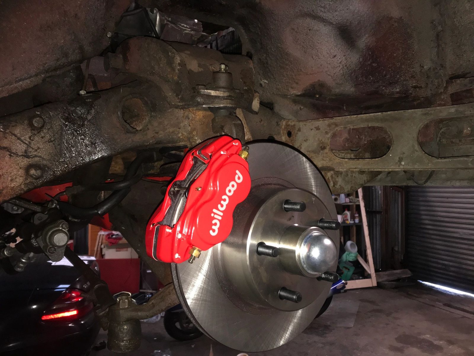 Front disc brake conversion on the Galaxie, with a red Wilwood caliper fitted