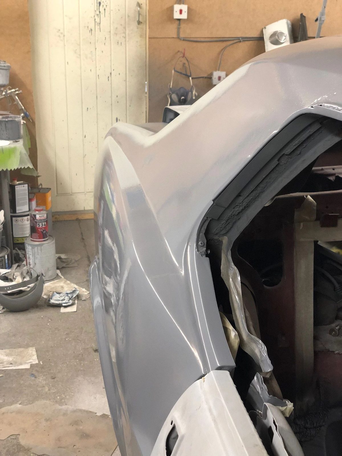 Close-up of a grey primed body panel on the Mustang in the workshop